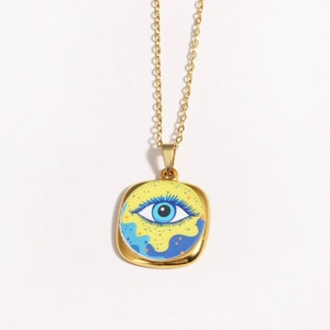 Close-up of vintage blue evil eye square pendant with golden chain on white background