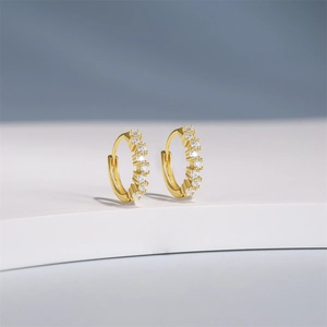 Close-up of gold s925 silver hoop earrings with clear white cubic zirconia stones