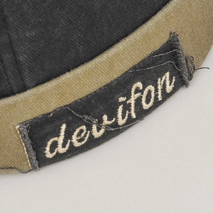 Vintage embroidery detail on cotton docker cap with contrast stitching and brand logo