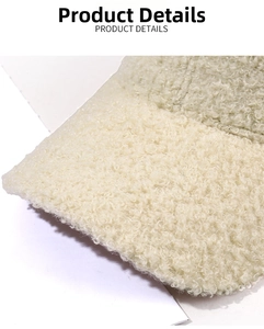 Close-up of off-white sherpa fleece texture on a warm winter baseball cap detail