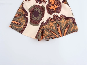 Detailed flat lay of women's vacation style shorts with vintage floral print patterns