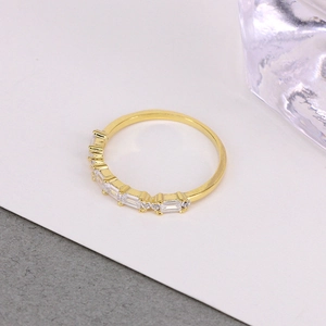 Detailed macro shot of gold ring with alternating rectangular and round crystals