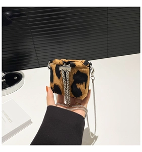 Detailed close-up of mini leopard print shoulder bag with elegant silver chain strap