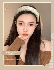 Close-up of beige knitted wide headband with ribbed texture for high crown hair styling