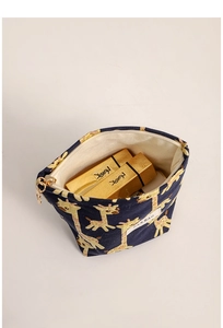 Internal view of navy blue giraffe makeup bag with gold zipper and lipstick storage