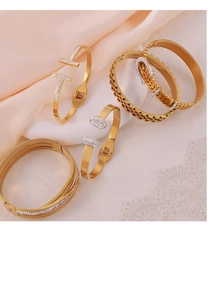 Detailed view of luxury gold-plated titanium bracelets with crystal geometric accents