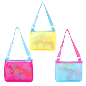 Detail view of mesh beach bags in yellow, pink and blue with adjustable shoulder straps