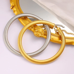 Detail of gold and silver choker necklace featuring a ribbed texture and adjustable chain