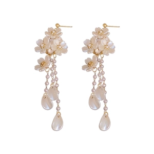 Elegant floral drop earrings with white flower clusters and pearl tassel pendants
