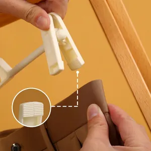 Non-slip white plastic trouser hanger with strong grip clips for wardrobe organization
