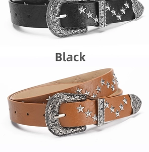 Detail of vintage western PU leather belts with star rivets and engraved buckle
