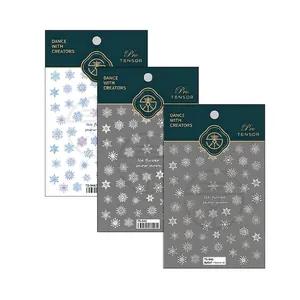Three-piece snowflake nail art sticker set with blue and white designs for winter manicures