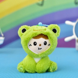 Detail view of a cute plush doll keychain wearing a vibrant green frog costume charm