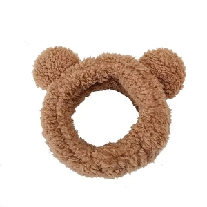Plush brown bear ear headband made of soft synthetic fur for facial cleansing and skincare