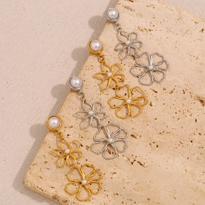 Detail of 18K gold and silver plated hollow flower earrings with pearl accents