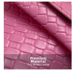 Macro shot of pink woven leather texture showing the premium craft detail on the handbag