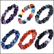 Macro view of six natural chakra stone bracelets with lava and tiger eye beads