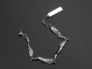 Detailed view of silver irregular textured metal link bracelet on black background
