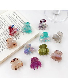 Collection of mini acetate hair claws with marble and leopard print patterns for women