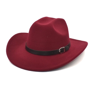 Detailed macro view of burgundy wool felt cowboy hat with black belt and metal buckle