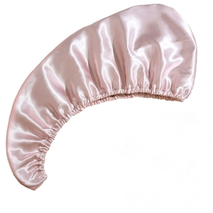 Detail of soft pink satin hair bonnet featuring high-elastic band and smooth silk texture