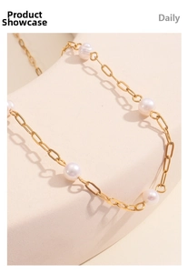 Close-up of elegant 18K gold paperclip chain necklace with white freshwater pearls