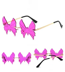 Detailed views of rimless butterfly sunglasses with pink lenses and crystal accents