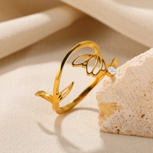 Macro shot of gold adjustable ring featuring hollow flower design and zircon inlay