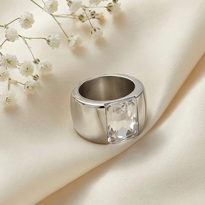 Macro view of a wide silver titanium ring with a large emerald-cut clear gemstone