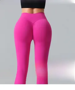 Detail of high-waist yoga pants with scrunch butt lifting seam in bright pink fabric