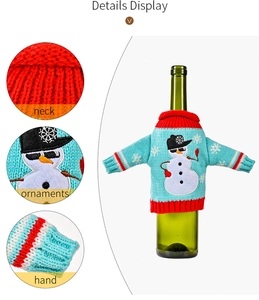 Detail view of blue knitted Christmas wine bottle cover with snowman embroidery