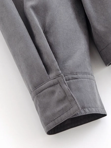 Close-up of grey drawstring windbreaker sleeve showing high-quality twill fabric texture