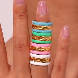 Close-up of 18K gold plated rings with water ripple texture and colorful enamel glaze