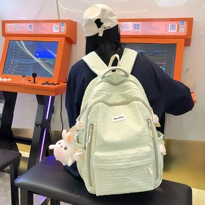 Mint green textured bubble fabric backpack with a cute plush rabbit pendant charm