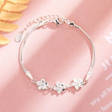 Silver flower bracelet with three cherry blossom charms and adjustable lobster clasp chain