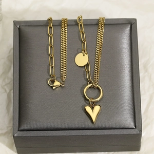 Golden double-layer titanium steel necklace with heart pendant on jewelry box
