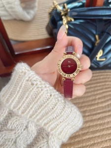 Detail of elegant gold case and red leather strap on luxury vintage women's watch