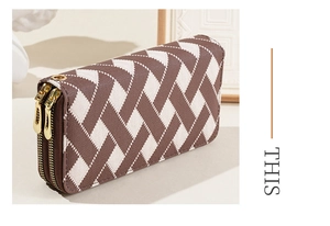 Close-up of brown and white woven pattern on long double-zipper wallet with gold hardware