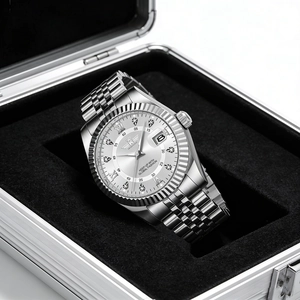 Detail view of a silver steel men's watch with calendar function in a black gift box