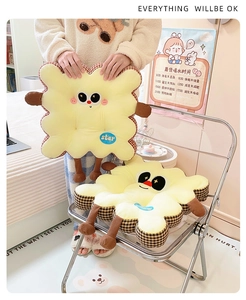 Detail of cute cookie plush cushion with star embroidery and plaid pattern edges