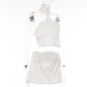 Detail view of a white halter crop top and mini skirt set on a studio mannequin