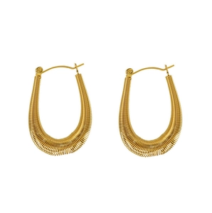 Detailed view of U-shaped gold earrings with unique coiled wire texture and secure latch