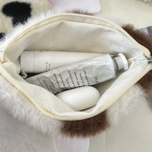 Top view of plush leopard print makeup bag showing the spacious cream fabric lining