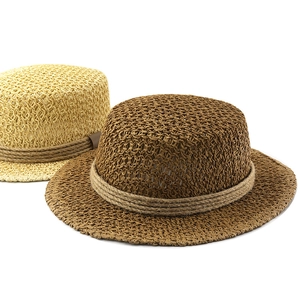 Detail view of woven straw boater hats in beige and dark coffee with hollow mesh texture