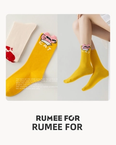 Detail of yellow cotton socks with cute 3D cat ears and knitted CAT lettering
