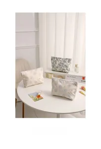 Detailed view of floral canvas makeup bags with zippers in multiple elegant patterns