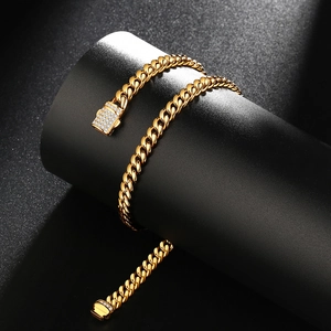 Detail of gold-plated Cuban link chain with sparkling diamond-encrusted buckle on stand