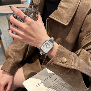 Elegant silver square watch for women with stylish chain strap on model's wrist