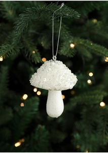 Close-up of white sequined mushroom Christmas ornament hanging on a tree with bokeh lights