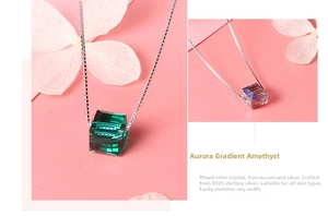 Macro detail of cube Austrian crystal pendants in emerald and aurora purple s925 silver